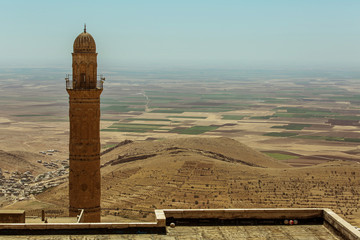 A Minaret and view of desert fields and blue sky
