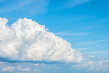 Naklejka na ściany i meble Beautiful large white clouds on a blue background.