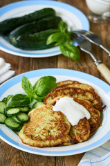 Zucchini fritters with sour cream, cucumbers and basil