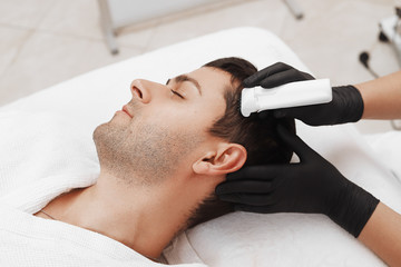  Face microneedling treatment with a meso roller.