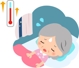 暑くて寝苦しそうなシニア女性