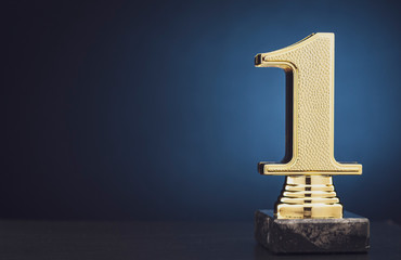 Champion or Winner gold trophy over blue