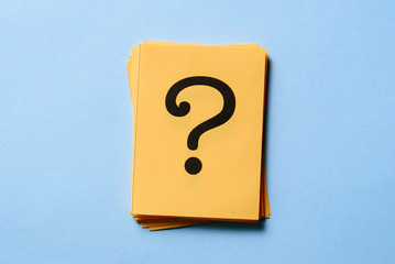 Stack of question marks on yellow cards
