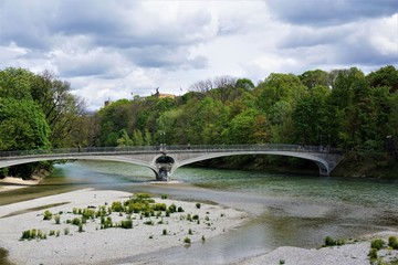 Kabelsteg bridge in Munich over the river Isar with Maximilianeum