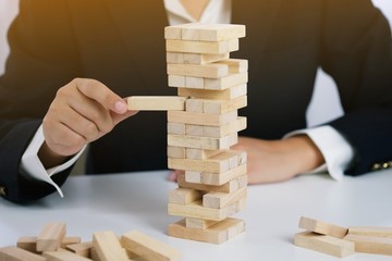 .Planning risk and strategy in businessman gambling placing wooden block.Business concept for...