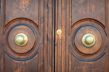 Old wooden door with golden metal door handles