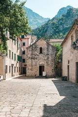 Fototapeta na wymiar Old historical buildings in the central district of ancient city Kotor in Montenegro