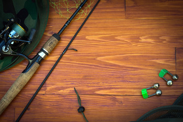 Fishing tackle-fishing spinning rods, hooks, floats and lures on wooden background © VIKTOR