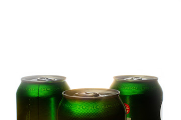 Three green cans of beer.