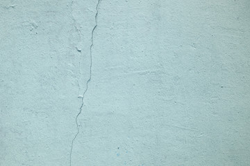 Old blue, pistachio wall with crack and plaster. textured background