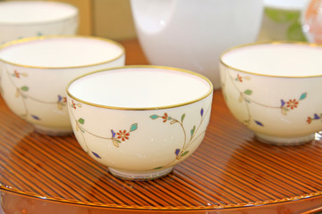 White bowls on brown platform