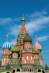 Fototapeta na wymiar Multicolor towers of St. Basil's Cathedral against the cloudy sky.