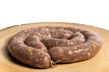 Raw homemade stuffed pork sausages isolated on a woodboard.