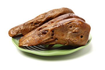 Duck head with marinated sauce on white background