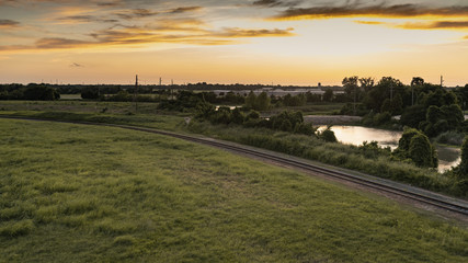Sunset in Sugar Land, Texas with a view of the creek and railways