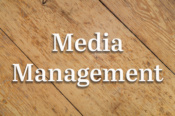 `Media Management` white text on a wooden home background. 