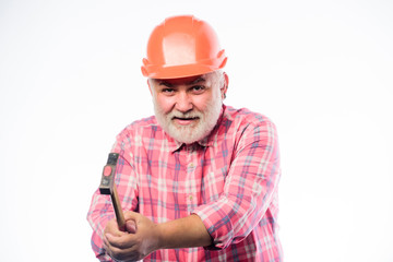 He loves his job. construction build. mature bearded man in hardhat. professional repairman in helmet. man builder use hammer tool. architect repair and fix. engineer worker