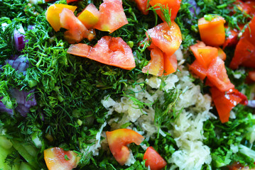 Useful and tasty vegetables, finely sliced ​​red tomatoes, green dill, blue onion and garlic for summer salad, salad ingredients.