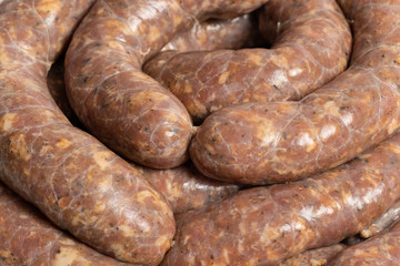 Closeup texture of freshly made raw homemade stuffed pork sausages.