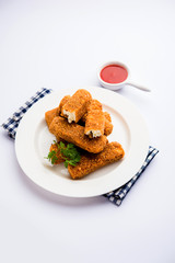 Kurkuri paneer fingers or pakora/pakoda snacks also known as Crispy Cottage Cheese Bars, served with tomato ketchup as a starter. selective focus
