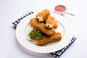 Kurkuri paneer fingers or pakora/pakoda snacks also known as Crispy Cottage Cheese Bars, served with tomato ketchup as a starter. selective focus