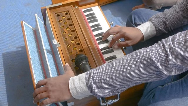 Playing harmonium close up shot