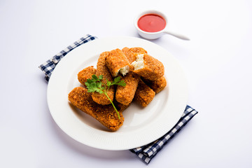 Kurkuri paneer fingers or pakora/pakoda snacks also known as Crispy Cottage Cheese Bars, served with tomato ketchup as a starter. selective focus