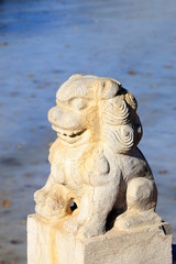Fototapeta na wymiar Carved stone lions in a park