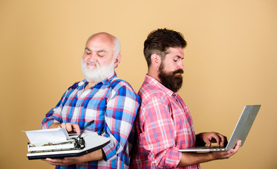 two bearded men. Vintage typewriter. technology generation battle. Modern life. father and son....
