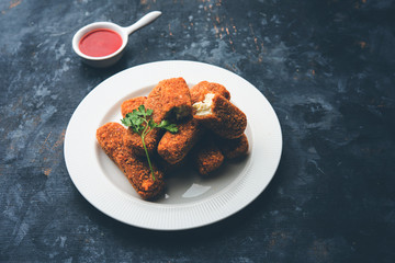 Kurkuri paneer fingers or pakora/pakoda snacks also known as Crispy Cottage Cheese Bars, served with tomato ketchup as a starter. selective focus