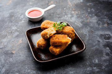 Kurkuri paneer fingers or pakora/pakoda snacks also known as Crispy Cottage Cheese Bars, served with tomato ketchup as a starter. selective focus