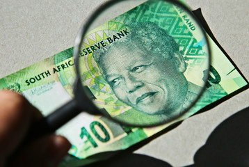 South African money concept image consisting of a magnifying glass and a 10 rand note. 