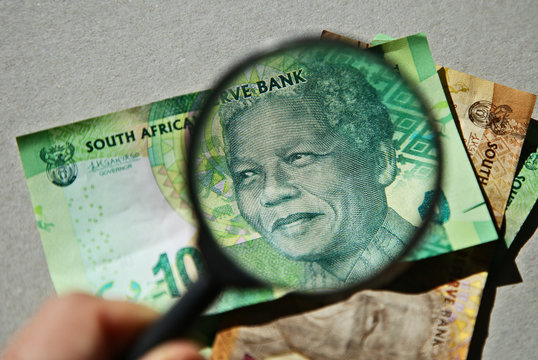 South African money concept image consisting of a magnifying glass and a 10 rand note. 