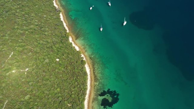 Aerial view of sailing boats in a beautiful turquoise lagoon on pine beach on Dugi Otok island, Croatia, beautiful seascape, overhead view