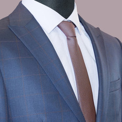 Man's suit: jacket, shirt & tie isolated on a mauve background. Business style. Elegant clothes. Men fashion industry. Stylish blue jacket, white cotton shirt. Office suit. Business jacket. Boss