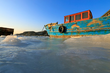 wooden boat in sea ice