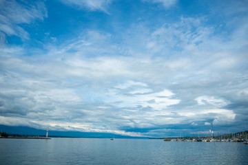 Charming panorama view of Geneva lake on clouds blue sky background