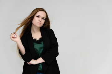 Concept portrait for the waist of a pretty girl, a young woman with long beautiful brown hair and a...