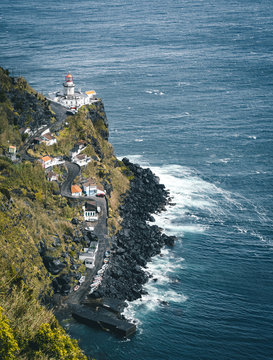 Dramatic view down to lighthouse on Ponta do Arnel, Nordeste, Sao Miguel Island, Azores, Portugal