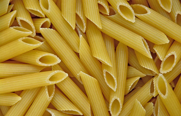 Penne pasta background. Top view. Nice Italian macaroni. Food concept. Space for a text.