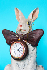 sculpture ceramic gray hare with a clock for a home interior