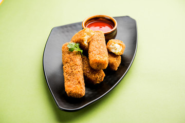 Kurkuri paneer fingers or pakora/pakoda snacks also known as Crispy Cottage Cheese Bars, served with tomato ketchup as a starter. selective focus