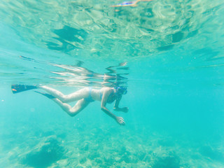 woman snorkeling in clear tropical waters - active holiday