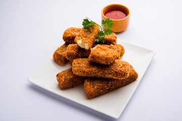 Kurkuri paneer fingers or pakora/pakoda snacks also known as Crispy Cottage Cheese Bars, served with tomato ketchup as a starter. selective focus