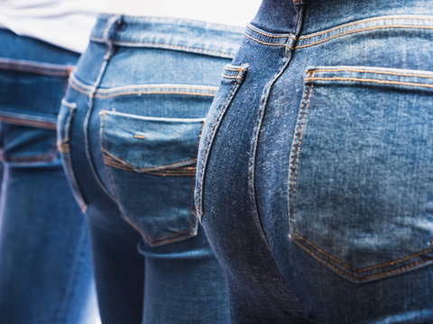 Close up of many blue jeans on women mannequin in the shop