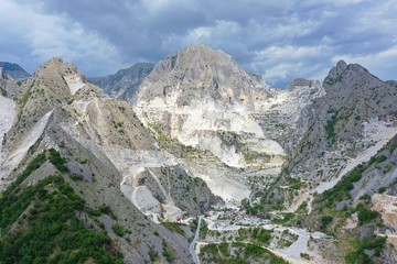 Aerial view of mountain of stone and marble quarries in the regional natural park of the Apuan Alps located in the Apennines in Tuscany, Massa Carrara Italy. Open pit mine