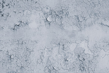 Natural pattern of peeling paint on a metal surface. Retro, cracked light grey paint on a wall. Abstract background, texture. Gray stains.