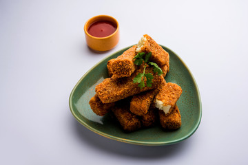 Kurkuri paneer fingers or pakora/pakoda snacks also known as Crispy Cottage Cheese Bars, served with tomato ketchup as a starter. selective focus