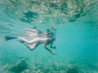 woman snorkeling in clear tropical waters - active holiday