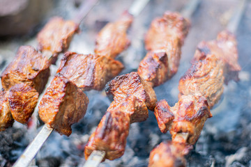 Grilled shish kebab on skewer. Roasted beef meat cooked at barbecue. Traditional eastern dish shashlik.
